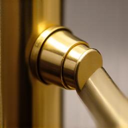 Close-up of polished, recycled brass bathroom fittings, gleaming gently.